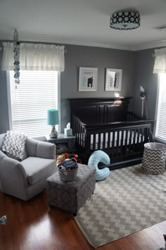 a baby's room with gray walls and furniture