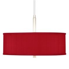 a red lamp shade hanging from a ceiling fixture