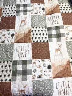 a baby quilt with the words little one written on it and an image of a deer