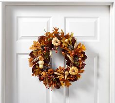 a white door with a wreath on it