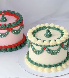 two cakes decorated with green and red icing on top of white cake platters