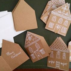 some brown paper with white designs on them and envelopes sitting next to each other