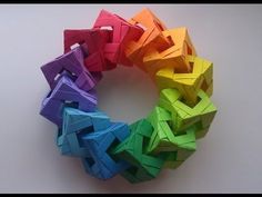 there are many different colored origami pieces arranged in a circle