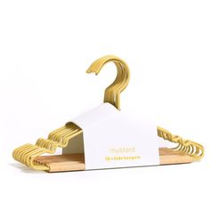 a gold metal hanger with a business card attached to it