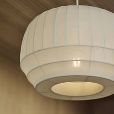 a white lamp hanging from the ceiling in a room