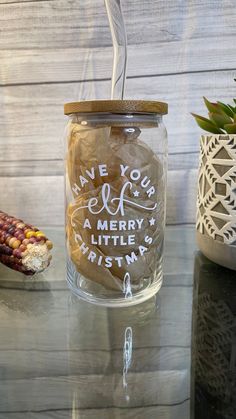 a glass jar with some writing on it and a string in the bottom that says have you merry little christmas