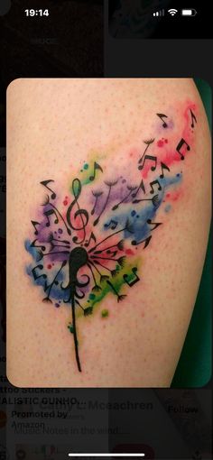 a colorful tattoo with musical notes on it