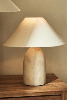 a table lamp sitting on top of a wooden dresser