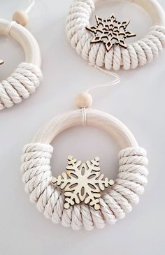 two white bracelets with gold snowflake charms hanging from the front and back