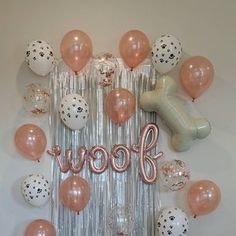 balloons and confetti are arranged around the word woof