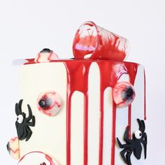 a decorated cake with red and white icing on it