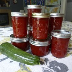 cucumbers and jars of pickles on a table