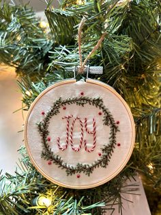 a cross stitch ornament hanging from a christmas tree