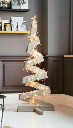 a white christmas tree with lights on it