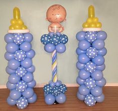 balloon columns with baby figures and balloons on them