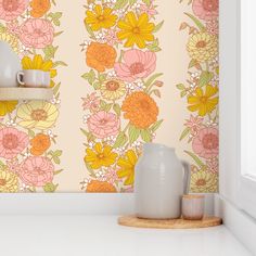 a vase sitting on top of a white counter next to a wallpapered wall