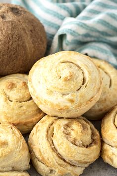 several cinnamon rolls stacked on top of each other next to a kiwi fruit ball