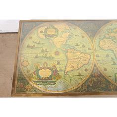 an old world map is displayed on the floor