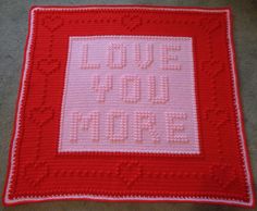 a red and white crocheted afghan with words on it