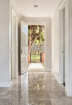 the hallway is clean and ready to be used as an entrance way for someone's home