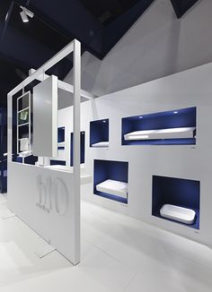 a bathroom with white walls and blue shelves