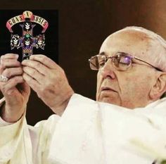 an old man holding up a small cross