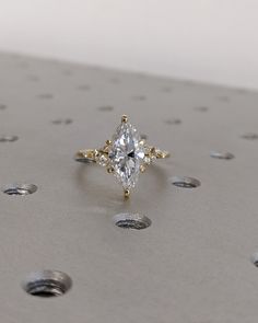 a diamond ring sitting on top of a metal surface