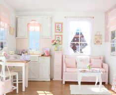 a room filled with furniture and decor in pastel pinks, whites and greens