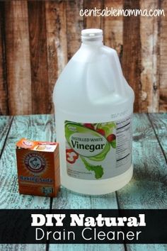 a gallon of vinegar next to a carton of vinegar cleaner on a wooden table