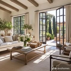 a living room filled with furniture and lots of windows