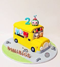 a birthday cake for two year old with an image of a bus on the side