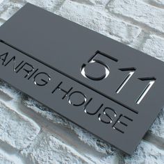 a sign that is on the side of a brick wall saying, 511 an iris house