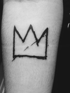 a black and white photo of a crown tattoo