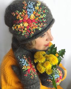 a woman wearing a hat and scarf with flowers on it