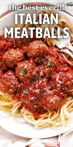 a white plate topped with spaghetti and meatballs