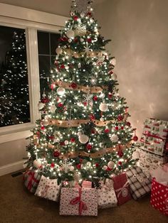 a christmas tree with presents under it