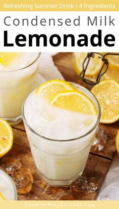 two glasses filled with lemonade sitting on top of a wooden table next to sliced lemons