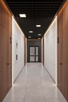 an empty hallway with wooden doors and white walls