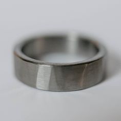 a close up view of a wedding ring on a white surface with only the center piece visible