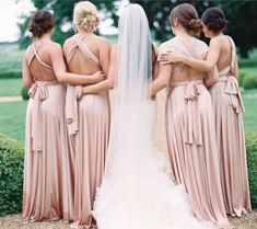 the bride and her four bridesmaids are looking at each other