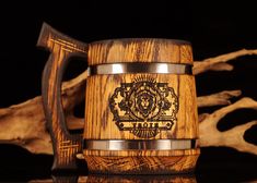 a wooden mug with an emblem on it