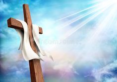 a wooden cross with white cloth on it against a blue sky and clouds stock photo