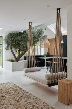 a living room filled with furniture and a tree