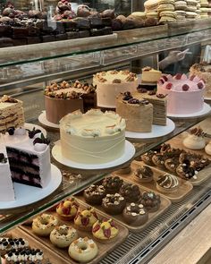 a display case filled with lots of different types of cakes