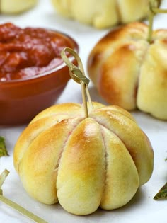 pepperoni pizza pumpkins are sitting on a table with dipping sauce in the background