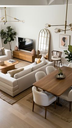 a living room filled with furniture and a flat screen tv sitting on top of a wooden table