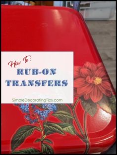 a close up of a red suitcase with flowers painted on it and the words how to rub - on transferers