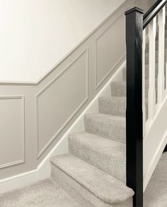 a staircase with carpeted steps and white walls