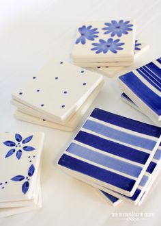 four blue and white napkins with flowers on them