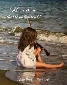 a woman sitting on the beach with a violin in her hand and a quote about music is an outcast of the soul